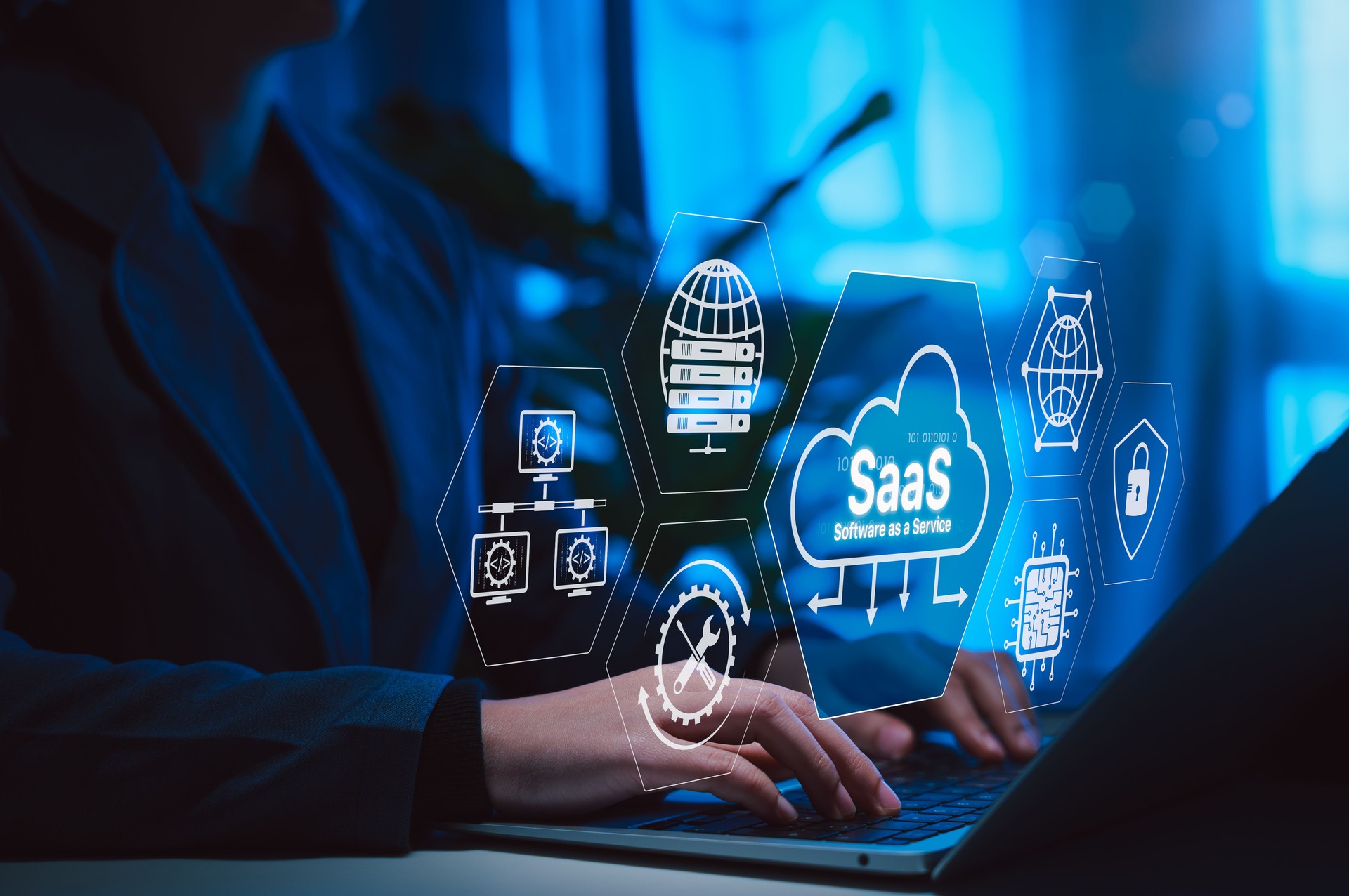 SaaS Software as a Service Cloud Computing Technology. Hands typing on laptop with SaaS icons, cloud systems, data servers, network elements, IT solutions, representing cloud based software solutions.